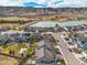 Stunning aerial view of a neighborhood with a lake and mountain views in the background at 2371 Pelican Bay Dr, Monument, CO 80132