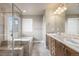 Luxurious bathroom with a glass-enclosed shower, a soaking tub, and a double vanity at 2371 Pelican Bay Dr, Monument, CO 80132