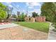 Large backyard with green grass, brick building, storage shed and wooden deck at 2690 Magnolia St, Denver, CO 80207