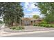 Charming brick home featuring a landscaped front yard and neat shrubs at 2690 Magnolia St, Denver, CO 80207