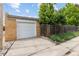 Exterior view of a white garage door and brick siding at 2690 Magnolia St, Denver, CO 80207