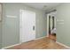 Inviting hallway showcasing hardwood floors, light green paint, and a view into the bedroom at 2690 Magnolia St, Denver, CO 80207