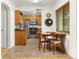 Charming eat-in kitchen with updated appliances, warm wood cabinets, and lots of sunlight at 2690 Magnolia St, Denver, CO 80207
