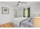 Comfortable bedroom features hardwood floors and green curtains, with ample natural light at 2690 Magnolia St, Denver, CO 80207