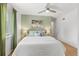 Cozy bedroom with hardwood floors, ceiling fan, and bright window at 2690 Magnolia St, Denver, CO 80207