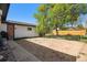 Fenced backyard with a dirt and concrete patio at 3685 S Hooker St, Englewood, CO 80110