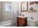 Bathroom featuring a shower and tub, vanity with cabinet, and a window at 3685 S Hooker St, Englewood, CO 80110