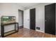 Bedroom featuring wood flooring, black doors and an aquarium on a stand at 3685 S Hooker St, Englewood, CO 80110