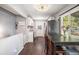 Bright dining area next to the modern kitchen with white cabinets and dark appliances at 3685 S Hooker St, Englewood, CO 80110