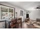 Dining space near a bright window, complemented by dark wood floors and adjacent living area at 3685 S Hooker St, Englewood, CO 80110