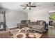 Comfortable living room featuring a ceiling fan, plush sectional, and stylish area rug at 3685 S Hooker St, Englewood, CO 80110
