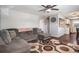 Cozy living room area open to the kitchen with hardwood flooring and a decorative rug at 3685 S Hooker St, Englewood, CO 80110