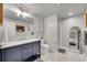 Elegant bathroom with a marble countertop vanity, modern lighting, and a glass-enclosed shower at 8839 Culebra St, Arvada, CO 80007