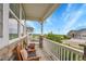 Inviting covered front porch with seating and views of the neighborhood at 8839 Culebra St, Arvada, CO 80007