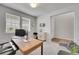 Functional home office with a wooden desk, additional seating, and ample natural light at 8839 Culebra St, Arvada, CO 80007
