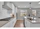 Bright kitchen featuring white subway tile backsplash, modern appliances, and ample counter space with a view to the outside at 8839 Culebra St, Arvada, CO 80007