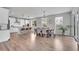Open-concept kitchen and dining area with modern white cabinets, stainless steel appliances, and a spacious dining table at 8839 Culebra St, Arvada, CO 80007