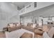 Open-concept living room featuring high ceilings, a staircase, and comfortable seating arrangements at 8839 Culebra St, Arvada, CO 80007
