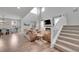 Bright and airy living space with a fireplace, custom built-ins, and a view of the staircase and dining area at 8839 Culebra St, Arvada, CO 80007