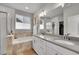 Bright main bathroom with double sinks, a soaking tub, a walk-in shower, and modern fixtures at 8839 Culebra St, Arvada, CO 80007