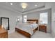 Cozy main bedroom featuring tray ceiling, neutral tones, and ensuite bathroom access at 8839 Culebra St, Arvada, CO 80007