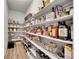 Walk-in pantry with organized shelving, fully stocked with various food items and household supplies at 8839 Culebra St, Arvada, CO 80007