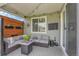 Cozy covered patio featuring stylish outdoor furniture and a view of the beautifully landscaped yard at 8839 Culebra St, Arvada, CO 80007