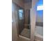 Modern bathroom featuring a glass shower enclosure and a separate tub at 1985 Basil St, Strasburg, CO 80136