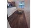Cozy dining area with wood floors adjacent to the kitchen and living area at 1985 Basil St, Strasburg, CO 80136