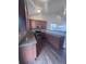 Functional kitchen featuring modern appliances, granite countertops, and wood cabinets at 1985 Basil St, Strasburg, CO 80136