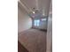 Open living room with a ceiling fan, carpeted floor, and natural light at 1985 Basil St, Strasburg, CO 80136