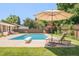 Spacious backyard oasis with a refreshing pool, lounge chairs, and well-manicured lawn at 3025 S Norman Ct, Denver, CO 80224