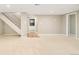 Finished basement area with staircase, carpet, and access to the utility room at 3025 S Norman Ct, Denver, CO 80224