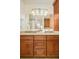 Bathroom boasts double vanity with granite counters and decorative lighting at 3025 S Norman Ct, Denver, CO 80224