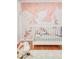 Charming Bedroom featuring swan mural, white crib, and rocking sheep at 3025 S Norman Ct, Denver, CO 80224