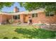 Beautiful brick home featuring a well-maintained lawn and a welcoming front entrance at 3025 S Norman Ct, Denver, CO 80224