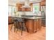 Spacious kitchen island features granite countertops, seating, and modern appliances at 3025 S Norman Ct, Denver, CO 80224