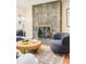Chic living room showcases a stone fireplace and cozy seating with modern decor at 3025 S Norman Ct, Denver, CO 80224