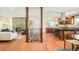 Open-concept living room with fireplace, hardwood floors, and modern staircase at 3025 S Norman Ct, Denver, CO 80224