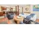 Open-concept living area flowing into kitchen with wood floors, plenty of natural light and modern furniture at 3025 S Norman Ct, Denver, CO 80224
