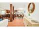 Open-concept living space featuring hardwood floors, dining area, and stainless steel kitchen appliances at 3025 S Norman Ct, Denver, CO 80224