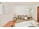 Bright main bedroom features natural light, hardwood floors, and neutral decor at 3025 S Norman Ct, Denver, CO 80224