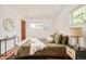 Bedroom with hardwood floors, natural lighting, and decorative mirror at 3025 S Norman Ct, Denver, CO 80224