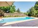 Backyard pool with patio, mature trees, and privacy fence create a serene outdoor retreat at 3025 S Norman Ct, Denver, CO 80224