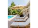 Tranquil poolside with lounge chairs, shade umbrella, and view of the home's exterior at 3025 S Norman Ct, Denver, CO 80224