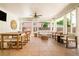 Inviting sunroom with tile floors, comfortable seating, and views of the backyard at 3025 S Norman Ct, Denver, CO 80224