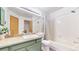 Clean bathroom featuring a tub/shower combo and green vanity at 1070 Milo Cir # B, Lafayette, CO 80026