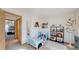 Cute bedroom with a toddler bed and natural light shining through the windows at 1070 Milo Cir # B, Lafayette, CO 80026