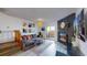 Bright living room featuring a brick fireplace, sliding glass doors, and comfortable gray sofa at 1070 Milo Cir # B, Lafayette, CO 80026