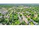 Aerial view of a residential neighborhood with tree-lined streets, houses, and roads surrounded by lush greenery at 962 S Potomac Way, Aurora, CO 80012